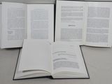 three open books sitting on a table next to each other