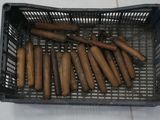 a lot of cigars in a basket on the floor