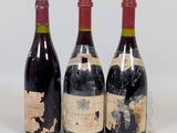 three bottles of wine sitting next to each other on a white surface