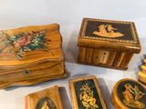 many wooden boxes with pictures on them on a table