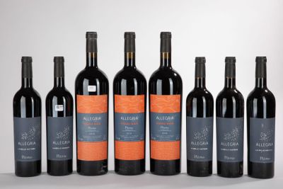 six bottles of red wine lined up in a row
