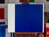 an easel with a blue and white painting on it