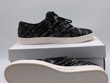 a pair of black and white sneakers sitting on top of a box