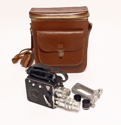 an old camera with a leather case and a metal object