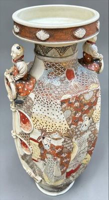 a large vase with many designs on it on a table
