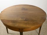 a wooden table with a wooden top on a carpeted floor