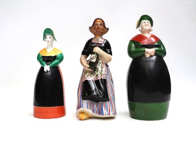 three ceramic figurines of women in different colors and sizes