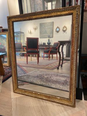 a large mirror sitting on a table in a room