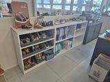 many pairs of shoes sitting on the shelves in the store