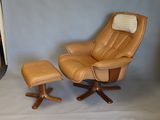 a chair and ottoman in front of a white backdrop
