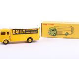 yellow and green toy truck with box on a white surface