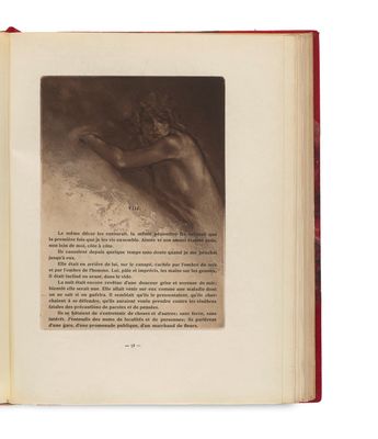 an open book with a picture of a naked woman on it