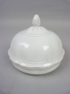 a white bowl with a lid on a table