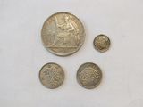 four different coins sitting on top of a table next to each other