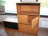 a wooden bookcase with a drawer in front of a window