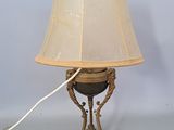 a lamp that is sitting on a table with a lamp shade on it