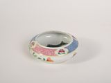 a small white bowl with a colorful design on it