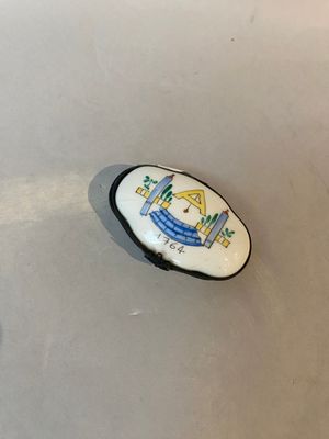 a small white plate with a picture of a house on it