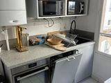 une cuisine équipée d'une cuisinière, d'un micro-ondes et d'un lave-vaisselle