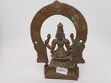 an old bronze statue of a woman holding a bowl of food