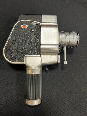 an image of an old movie camera on a black surface