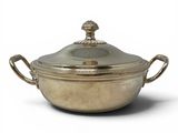 an antique silver plated casserole with a lid and handles