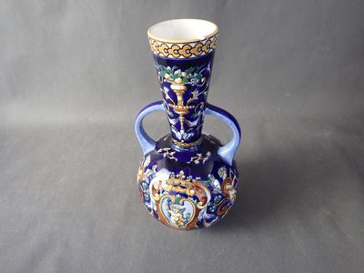 a blue vase with a gold and blue design on it
