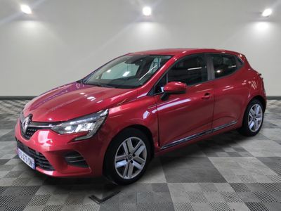 a red car parked in a garage with a checkered floor