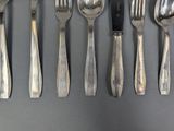 a lot of spoons and forks that are on the table
