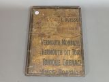 an old brass cigarette case with a label on it
