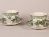 pair of green and white cups and saucers