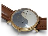 a watch that is sitting on a brown leather strap
