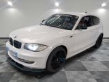 a picture of a white bmw car in a showroom