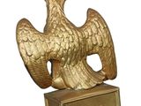 a golden bird on a pedestal with a crown on top of it