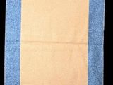 a blue and yellow towel hanging on a black wall