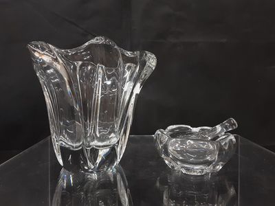 a glass vase and a glass ashtray on a table