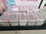 a lot of pink and white nail polishes on display