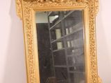 a mirror that is sitting on a shelf in a room
