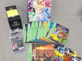 a lot of pokemon cards and a book on the couch