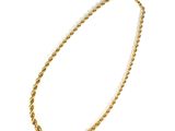 a close up of a gold necklace on a white background