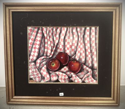 painting of two red apples on a checkered cloth in a gold frame