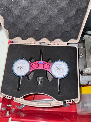 two dials in a tool case on a table