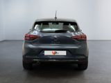 the rear end of a grey car in a white room