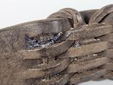 a close up of a brown leather shoe with laces on it