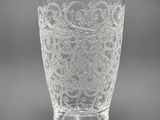 a clear glass vase with a floral design on it