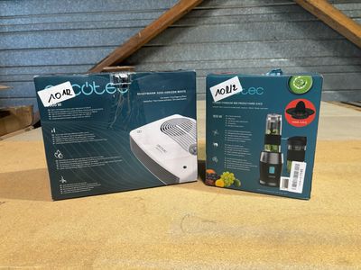 two boxes of air conditioner sitting on top of a wooden table