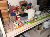 a cluttered kitchen with a lot of clutter on the shelves