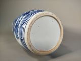 a blue and white vase sitting on a table