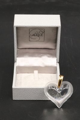 a small heart shaped box with a ring inside of it