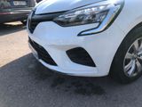 a close up of a white car parked in a parking lot
